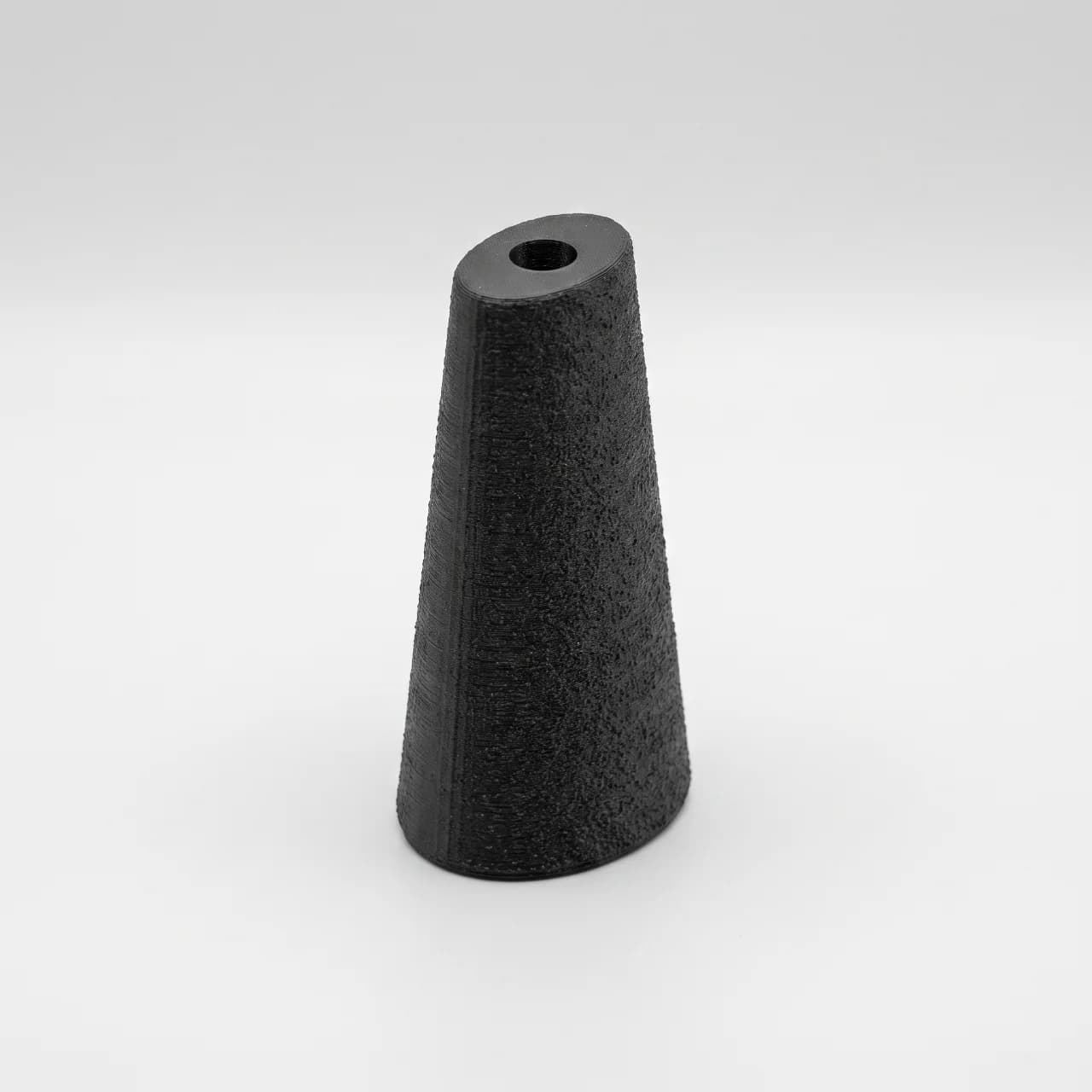 Elipsed Cone training handle standing upright, angled to show the elliptical taper and top bore