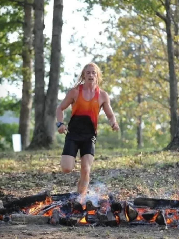 Cody Wood leaping a fire obstacle at Savage Race Georgia, 2018